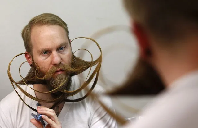 Participant Justin Kellermeier of the U.S. styles his beard for the Beard World Championship 2013 in Leinfelden-Echterdingen near Stuttgart November 2, 2013. Kellermeier needs more than 5 hours for his beard art work. More than 300 people from around the world compete in different moustache and beard categories. (Photo by Michaela Rehle/Reuters)