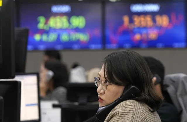 A currency trader watches monitors at the foreign exchange dealing room of the KEB Hana Bank headquarters in Seoul, South Korea, Wednesday, October 18, 2023. (Photo by Ahn Young-joon/AP Photo)
