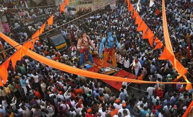 Hindu devotees gather around giant idols of Hindu god Rama, right, and his brother Lakshman during a religious procession to mark “Ram Navami” festival in Hyderabad, India, Saturday, March 28, 2015. Ram Navami celebrates the birth of Rama. (Photo by Mahesh Kumar A./AP Photo)