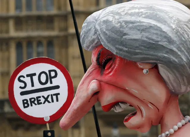A sculpture depicting Britain's Prime Minister Theresa May stands opposite Parliament as the protest against Brexit continuous in London, Wednesday, December 12, 2018. (Photo by Frank Augstein/AP Photo)