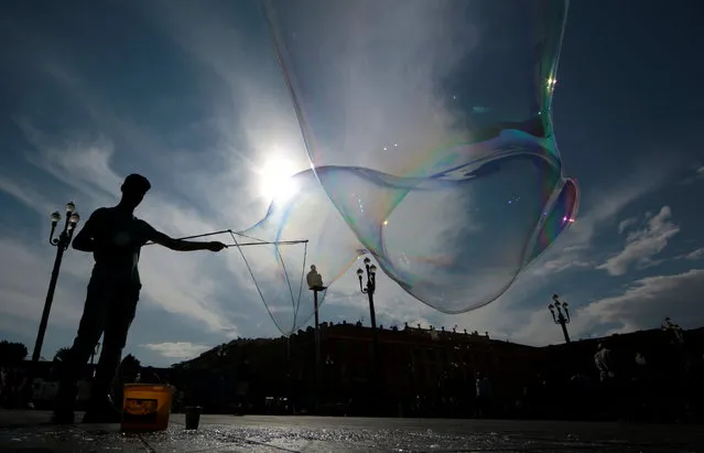  A street artist performs with soap bubbles in Nice, France, June 6, 2016. (Photo by Eric Gaillard/Reuters)