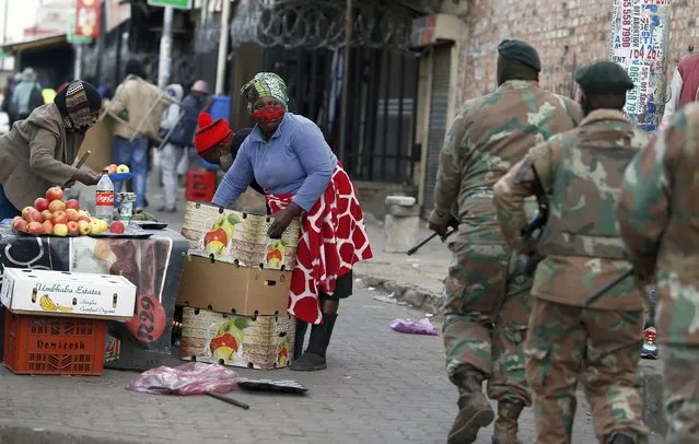 South African Defence Force soldiers on patrol in Alexandra Township, north of Johannesburg, Thursday, July 15 202. (Photo by AP Photo/Stringer)