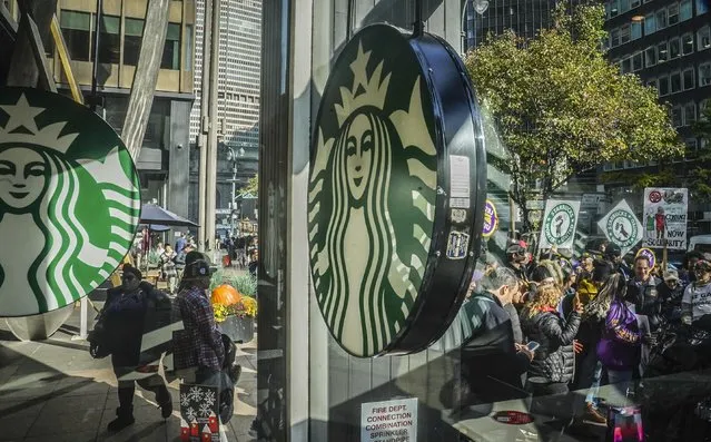 A coalition of unions and supporters join Starbucks workers at a rally outside a midtown Manhattan Starbucks coffee store, calling for “fair schedules and wages”, Thursday, November 16, 2023, in New York. (Photo by Bebeto Matthews/AP Photo)