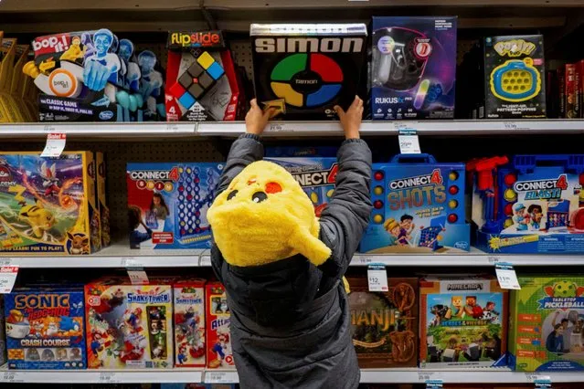 A child looks at toys in a Target store ahead of the Thanksgiving holiday and traditional Black Friday sales in Chicago, Illinois on November 21, 2023. (Photo by Vincent Alban/Reuters)