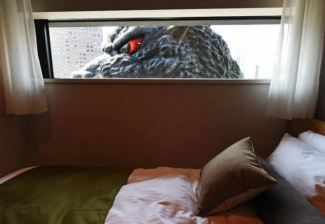  A life-size Godzilla head is seen through a window of the “Gozilla View Room” of Hotel Gracery Shinjuku at Kabukicho shopping district in Tokyo on April 9, 2015. The Godzilla is a main feature of the new commercial complex comprising a 970-room hotel, movie theathres and restaurants which will be open this month. (Photo by Toru Yamanaka/AFP Photo)