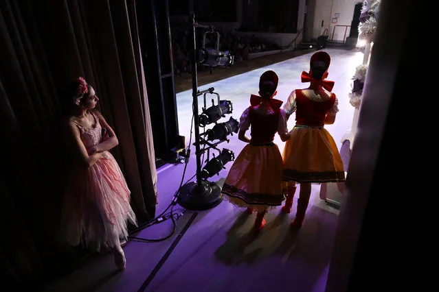 Elena Garcia, 15, left, waits for her cue backstage during a Metropolitan School of Arts production of the Nutcracker at Rachel M. Schlesinger Concert Hall and Arts Center on Sunday December 10, 2023 in Alexandria, VA. (Photo by Matt McClain/The Washington Post)