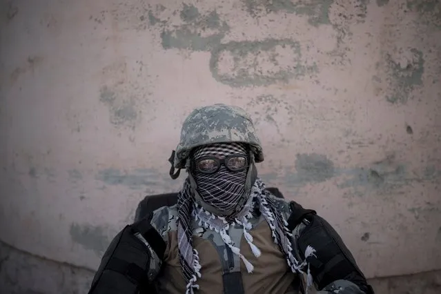 A Taliban fighter guards the entrance of the Pul-e-Charkhi prison in Kabul, Afghanistan, Monday, September 13, 2021. Pul-e-Charkhi was previously the main government prison for holding captured Taliban and was long notorious for abuses, poor conditions and severe overcrowding with thousands of prisoners. Now after their takeover of the country, the Taliban control it and are getting it back up and running, current holding around 60 people, mainly drug addicts and accused criminals. (Photo by Felipe Dana/AP Photo)