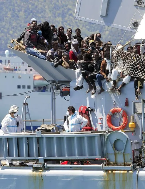 Migrants stand on board of Italian Navy ship Chimera before to be disembarked in the southern harbour of Salerno April 22, 2015. The European Union must take a collective stand to tackle migrant trafficking at its source in African countries, Italy's Prime Minister Matteo Renzi said on Wednesday ahead of an emergency summit of the bloc's leaders to discuss the crisis. (Photo by Ciro De Luca/Reuters)