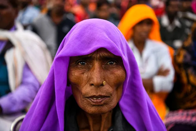 An Indian participant of the “Dignity March” looks on as she attends the culmination of the march at Ramleela Ground in New Delhi on February 22, 2019. Thousands of women have joined the Dignity March to walk 10,000 kilometres (6,200 miles) across India, starting in Mumbai on December 20, 2018 and ending in the Indian capital New Delhi on February 22, to raise awareness for sexual assault survivors and their fight for justice, and to campaign for an end to sexual violence against women and children. (Photo by Chandan Khanna/AFP Photo)
