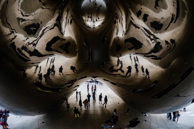 People spend time at the Cloud Gate sculpture in Millennium Park in Chicago, Illinois, U.S., September 5, 2021. (Photo by Hannah Beier/Reuters)