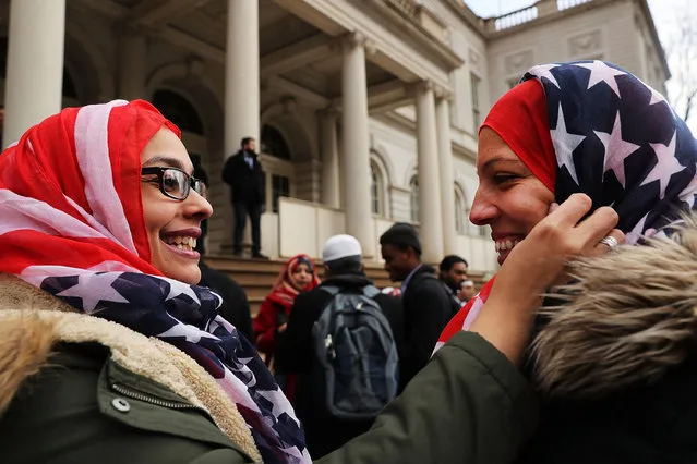 New York City Police Officers Aml Elsokary (left) and Maritza Morales wear  American Flag head scarfs at an event at City Hall for World Hijab Day on February 1, 2017 in New York City. The day was started five years ago when a Muslim in New York invited other women to experience what it is like to wear a hijab every day in America. The day is now celebrated in cities around the world. (Photo by Spencer Platt/Getty Images)