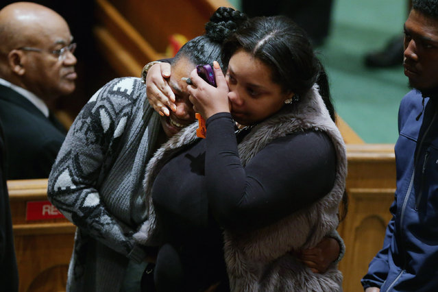Mourners comfort one another during the funeral for Freddie Gray at the New Shiloh Baptist Church during his funeral April 27, 2015 in Baltimore, Maryland. Gray, 25, was arrested for possessing a switch blade knife April 12 outside the Gilmor Homes housing project on Baltimore's west side. According to his attorney, Gray died a week later in the hospital from a severe spinal cord injury he received while in police custody. (Photo by Chip Somodevilla/Getty Images)