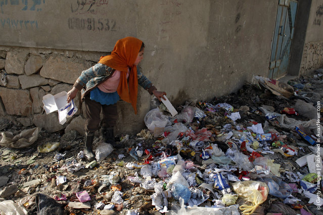 Wazhma, 7, collects garbage from the streets to help her family after attending class at the Aschiana school in Kabul, Afghanistan