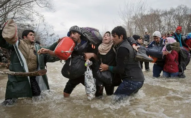 A handout photo made available by the World Press Photo (WPP) organization on 13 February 2017 shows a picture by The Associated Press photographer Vadim Ghirda that won the Contemporary Issues – Second Prize, Singles award of the 60th annual World Press Photo Contest, it was announced by the WPP Foundation in Amsterdam, The Netherlands on 13 February 2017. Caption: A woman is supported by two men while crossing a river, as refugees attempt to reach Macedonia on a route that would bypass the border fence, on 14 March 2016. Hundreds of refugees walked out of an overcrowded camp on the Greek-Macedonian border on this day, shortly after the closure of Macedonia's borders, determined to head north despite the dangers of the crossing. (Photo by Vadim Ghirda/EPA/World Press Photo)