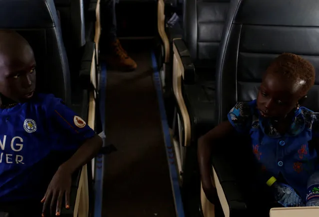 Machiey Mario, 8 (L), and Nyawan Mario, 4, fly on a United Nations plane to Juba where they will be reunited with their mother, near Bentiu, South Sudan, February 13, 2017. (Photo by Siegfried Modola/Reuters)