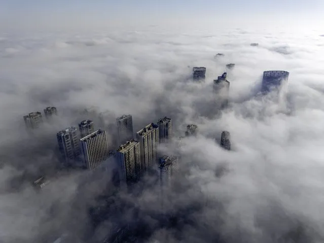 High-rise buildings are looming in advection fog in the Qingjiangpu district of Huai'an city, Jiangsu province, China, on March 15, 2024. (Photo by Costfoto/NurPhoto/Rex Features/Shutterstock)