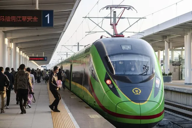 In this photo released by Xinhua News Agency, an electric multiple unit (EMU) train of the China-Laos Railway arrives at Yuxi Railway Station in Yuxi in southwestern China's Yunnan Province, Friday, December 3, 2021. The China Laos railway is one of hundreds of projects under Beijing's Belt and Road Initiative to build ports, railways and other facilities across Asia, Africa and the Pacific. (Photo by Hu Chao/Xinhua via AP Photo)