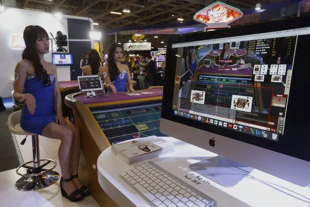 Attendants demonstrate “Live Dealer”, a service for online gamblers, at the Global Gaming Expo (G2E) Asia in Macau, China May 19, 2015. (Photo by Bobby Yip/Reuters)
