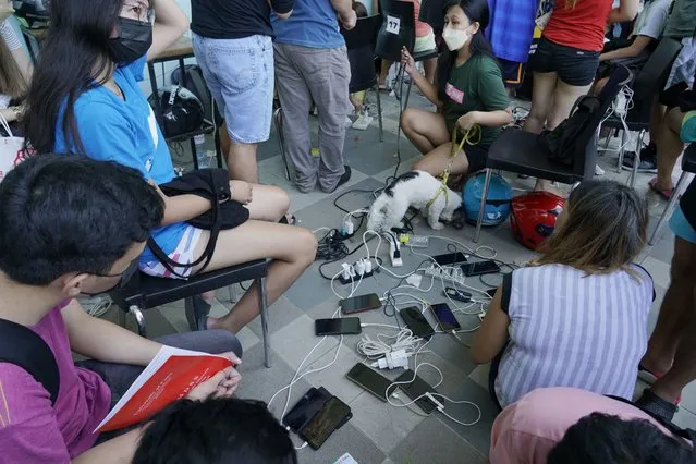 Residents charge their phones for free at a mall as most parts of Cebu city, central Philippines, remain without electricity due to Typhoon Rai on Saturday, December 18, 2021. (Photo by Jay Labra/AP Photo)