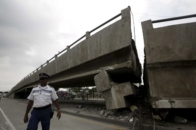 An officer walks beside a collapsed bridge after an earthquake struck off the Pacific coast, in Guayaquil, Ecuador, April 17, 2016. (Photo by Henry Romero/Reuters)