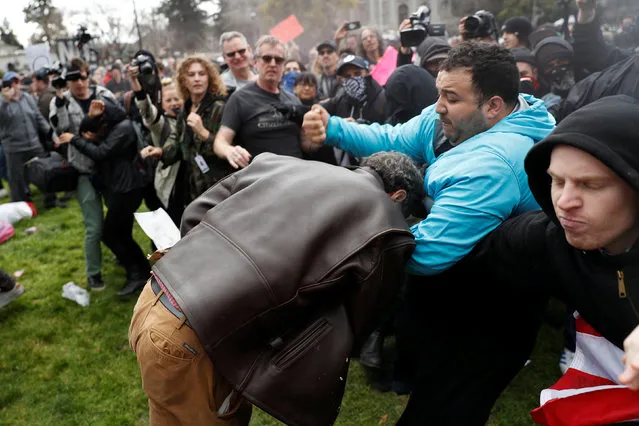A demonstrator in support of U.S. President Donald Trump (L) scuffles with a counter-protester during a “People 4 Trump” rally in Berkeley, California March 4, 2017. (Photo by Stephen Lam/Reuters)