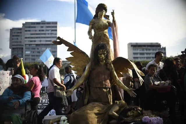 People protest demanding justice for the girls killed in a fire at a state-run shelter, at Constitution Square in Guatemala City on March 11, 2017. Guatemala recoiled in anger and shock at the deaths of at least 39 teenage girls in a fire at a government-run shelter where staff has been accused of sexual abuse and other mistreatment. All the victims were aged between 14 and 17. (Photo by Johan Ordonez/AFP Photo)