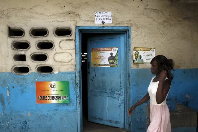 A woman walks after her registration on the electoral list ahead of the October 2015 presidential elections at an enrollment center of Wiilliamsville, an area of Abidjan June 30, 2015. (Photo by Luc Gnago/Reuters)