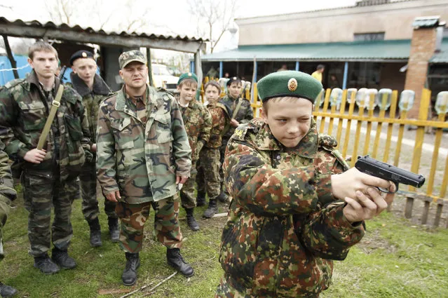 A student from the General Yermolov Cadet School takes part in weapons training during a two-day field exercise near the village of Sengileyevskoye, just outside the south Russian city of Stavropol April 13, 2014. (Photo by Eduard Korniyenko/Reuters)