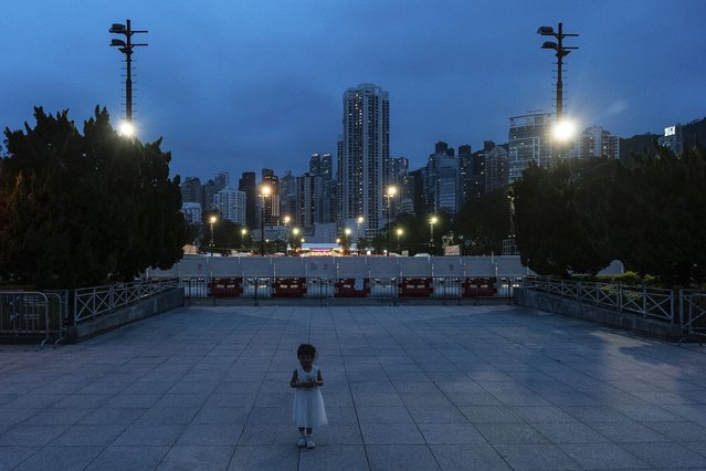A child stands in front of a closed Victoria Park, the city's venue for the annual 1989 Tiananmen massacre vigil, on the 35th anniversary of China's Tiananmen Square crackdown, in Hong Kong, Tuesday, June 4, 2024. (Photo by Chan Long Hei/AP Photo)