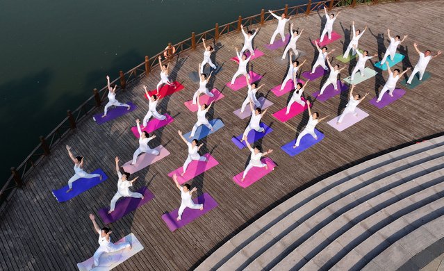 Yoga lovers are practicing yoga at Fengfeng Health Theme Cultural Park in Handan, China, on June 20, 2024. (Photo by Costfoto/NurPhoto/Rex Features/Shutterstock)