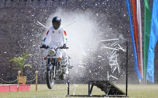 A Central Reserve Police Force (CRPF) soldier performs a stunt during the 83rd raising day ceremony of the CRPF at Maulana Azad Stadium in Jammu, India, Wednesday, March 16, 2022. (Photo by Channi Anand/AP Photo)