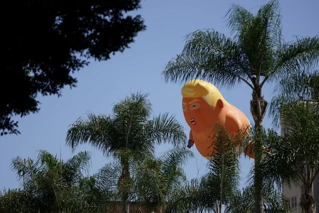 Protesters fly a giant Baby Trump balloon next to the hotel where U.S. President Donald Trump is holding a fundraising luncheon in San Diego, California, U.S., September 18, 2019. (Photo by Mike Blake/Reuters)