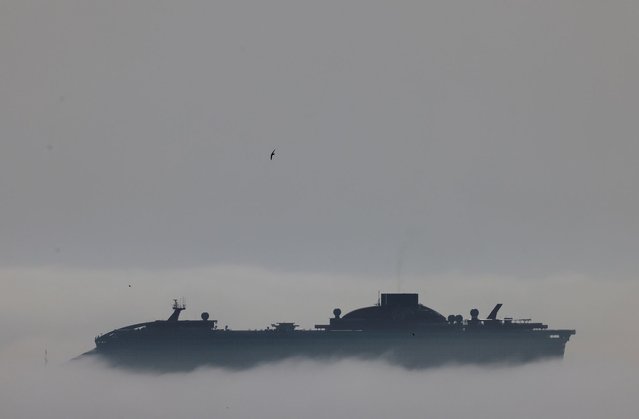 A cruise ship is seen through the fog outside the port in Larnaca, Cyprus, on April 4, 2024. (Photo by Yiannis Kourtoglou/Reuters)