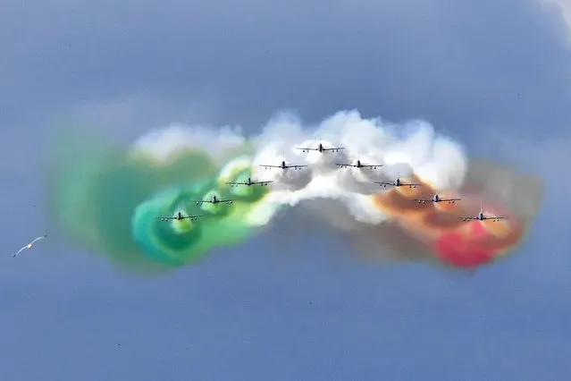 The Italian Air Force aerobatic unit Frecce Tricolori (Tricolor Arrows) spreads smoke with the colors of the Italian flag over the city of Rome on June 2, 2016 as part of the Republic Day ceremony. (Photo by Tiziana Fabi/AFP Photo)