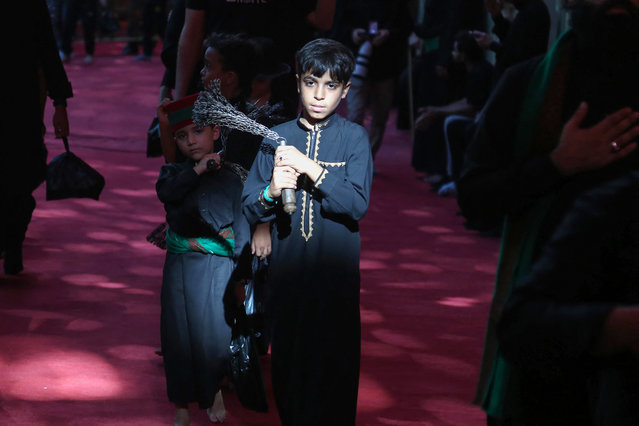 Shiite Muslim devotees take part in a mourning ritual during Ashura, a 10-day period commemorating the seventh century killing of Prophet Mohammed's grandson Imam Hussein, at the Imam Abu Al-Fadl Al-Abbas shrine in Iraq's central holy city of Karbala on July 13, 2024. (Photo by Mohammed Sawaf/AFP Photo)