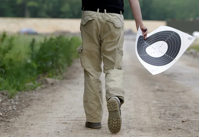 A shooting instructor walks through a forest shooting range near the village of Visnova, Czech Republic, June 9, 2016. (Photo by David W. Cerny/Reuters)