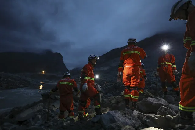 In this Saturday, June 24, 2017 photo released by China's Xinhua News Agency, rescuers work at the site of a landslide in Xinmo village in Maoxian County in southwestern China's Sichuan Province. (Photo by Jiang Hongjing/Xinhua via AP Photo)