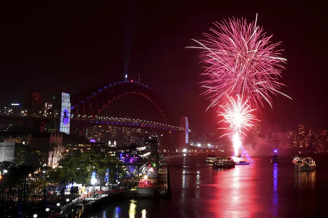 The 9pm family fireworks explode over the Sydney Opera House and Sydney Harbour Bridge on Sydney Harbour during New Year's Eve celebrations in Sydney, Tuesday, December 31, 2019. (Photo by Dean Lewins/AAP Image via AP Photo)
