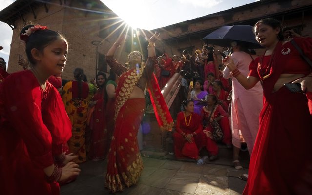 Nepalese women dance at the Pashupatinath temple during Teej festival celebrations in Kathmandu, Nepal, Friday, September 6, 2024. (Photo by Niranjan Shrestha/AP Photo)