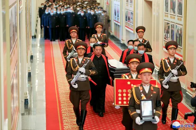 This picture taken on May 22, 2022 and released from North Korea's official Korean Central News Agency (KCNA) on May 23 shows North Korean leader Kim Jong Un (C-L) carrying the coffin of late Hyon Chol Hae, Marshal of the Korean People's Army and general adviser to the ministry of national defence during his funeral at the April 25 House of Culture in Pyongyang. (Photo by KCNA via KNS/AFP Photo)