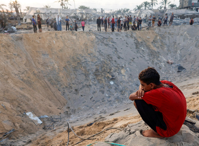 A Palestinian boy looks on at the site following Israeli strikes on a tent camp sheltering displaced people, amid the Israel-Hamas conflict, at the Al-Mawasi area in Khan Younis, in the southern Gaza Strip on September 10, 2024. (Photo by Mohammed Salem/Reuters)