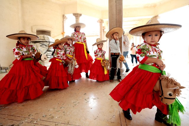 A student dressed as a “Escaramuza Charra” (woman on horseback) gallops her wooden stick horse during a class at the Charreria Sports Academy Caballito de Palo, in Ameca, Jalisco state, Mexico, September 7, 2024. Charreria Sports Academy “Caballito de Palo” offers classes for girls aged 3-8 using a wooden hobby horse, promoting Mexican traditions during September Mexico's Independence celebrations. The traditional charreria is a sport arising from equestrian activities and livestock traditions and has been a part of Mexican culture since colonial times. It was declared the Intangible Cultural Heritage of Humanity by UNESCO in 2016. (Photo by Ulises Ruiz/AFP Photo)