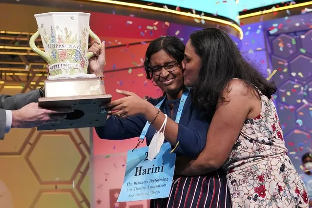 Harini Logan, 14, from San Antonio, Texas, gets a kiss from her mom Rampriya Logan on stage as she celebrates winning the Scripps National Spelling Bee, Thursday, June 2, 2022, in Oxon Hill, Md. (Photo by Alex Brandon/AP Photo)