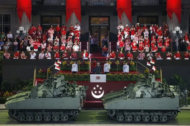 Singapore's President Tony Tan (C) watches as tanks roll past during Singapore's Golden Jubilee parade at Padang near the central business district August 9, 2015. (Photo by Edgar Su/Reuters)