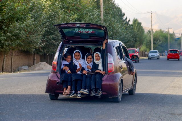 Afghan school girls travel in a car along a road in Faizabad district of Badakhshan province on September 18, 2024. (Photo by Omer Abrar/AFP Photo)