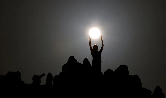 People celebrate the summer solstice at the Kokino megalithic observatory, near the city of Kumanovo, Macedonia June 21, 2016. (Photo by Ognen Teofilvovski/Reuters)
