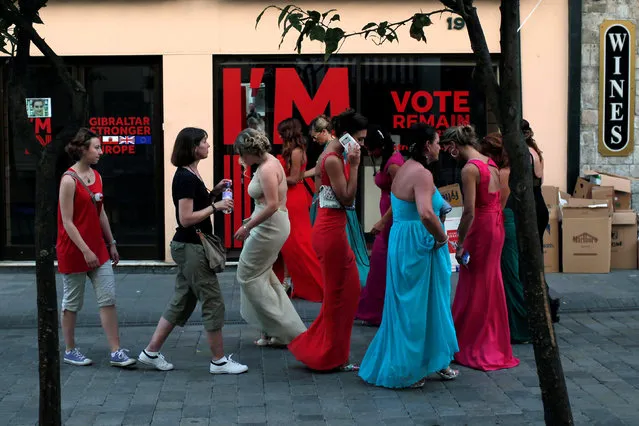 A group of Gibraltarian women (R) walk next to the closed “Gibraltar stronger in Europe” campaign office after a wedding outside a church in the British overseas territory of Gibraltar, historically claimed by Spain, June 24, 2016, after Britain voted to leave the European Union in the EU BREXIT referendum. (Photo by Jon Nazca/Reuters)