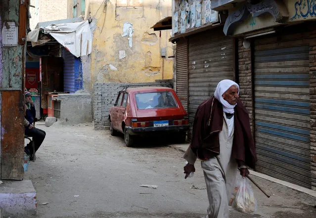 People walk by closed shops and old houses at Manshiet Nasser shanty town in the capital Cairo, Egypt February 13, 2017. (Photo by Amr Abdallah Dalsh/Reuters)