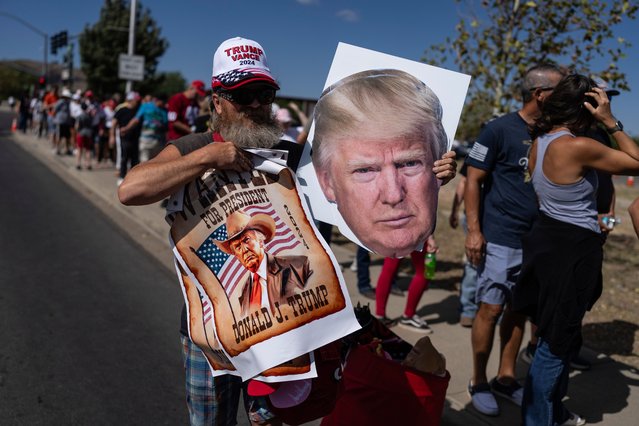 A street vendor sells posters while supporters of Republican presidential nominee former President Donald Trump wait in a line to enter a campaign rally at the Findlay Toyota Arena, Sunday, October 13, 2024, in Prescott Valley, Ariz. (Photo by Rodrigo Abd/AP Photo)