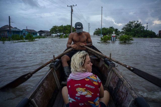 People navigate a flooded street in a row boat after Hurricane Helene passed through Guanimar, Cuba, on Wednesday, September 25, 2024. (Photo by Ramon Espinosa/AP Photo)